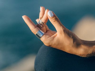 Close-up on hands in a meditative gesture.
